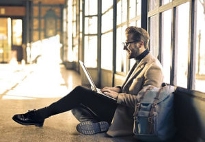 How To Fix Writer's Block-A Man Finding inspiration Writing on his Laptop in an Airport-Image 4 of the Post