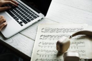 Benefits Of A Gig Economy- an image of a laptop and some writing music on paper third image of post