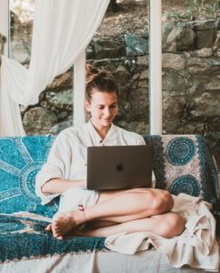 Benefits Of A Gig Economy - image of a women sitting on a couch on her laptop this is the fourth image of post