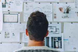 How To Become A Polymath - It Is Easier than It Sounds. Image 2 in Blog Post of a man looking at a board Full of Information