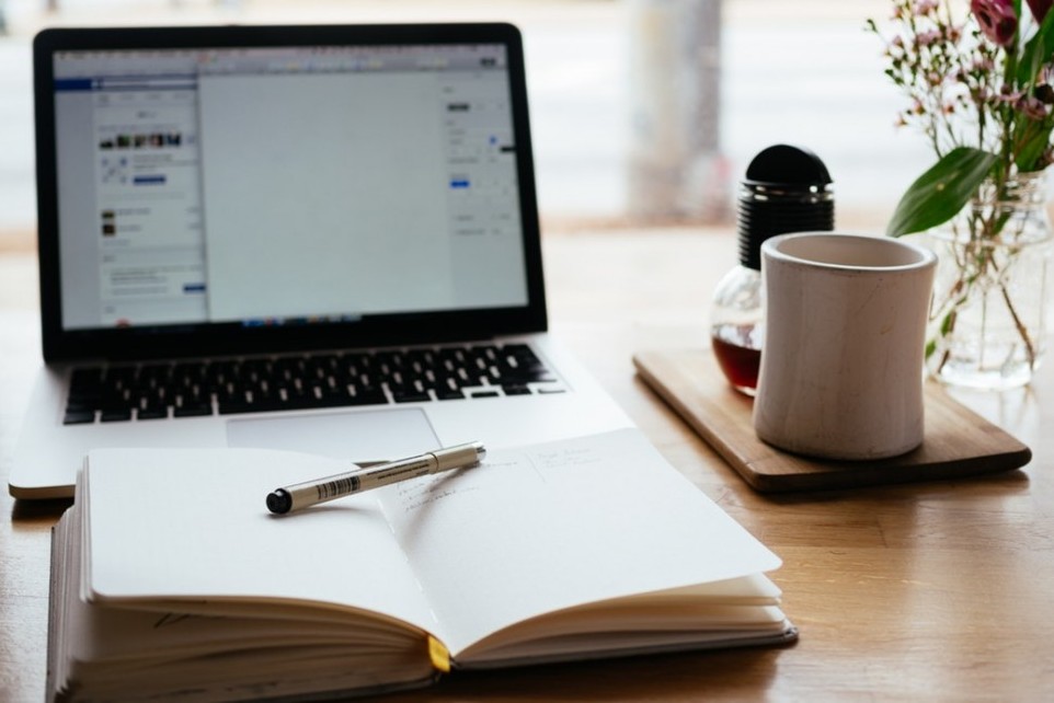 How To Overcome The Fear Of Failure - image 4 for article a picture of a laptop and writing note pad with a pen and coffee cup