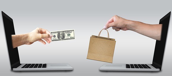 How To Overcome The Fear Of Failure - image 2 for article two hands coming out of two laptops sharing money for products